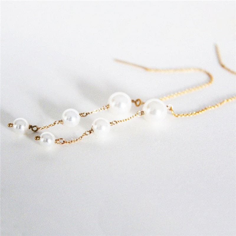 Boucle d&#39;oreille chaine traversante en or avec perle